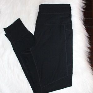 RBX, black leggings with  side pockets and  ribbed panels and ribbed cuffs